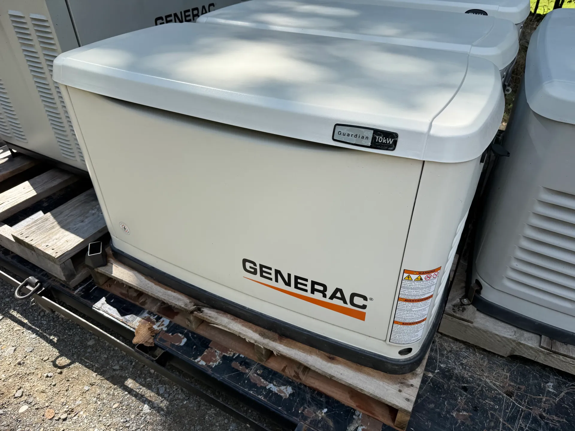 White Generac Guardian generator with a visible 10 kW badge