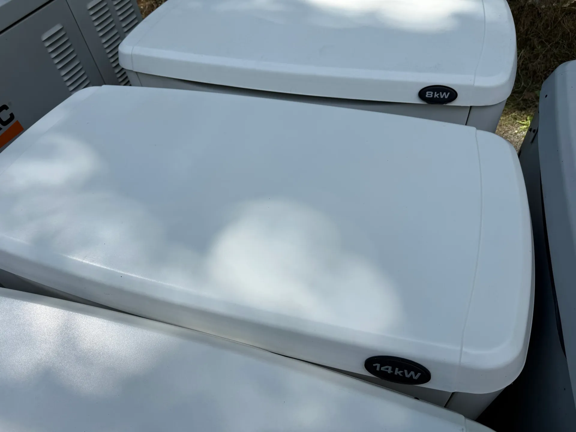 Two white generators shown together; the 14 kW Guardian is pictured behind the 10 kW unit