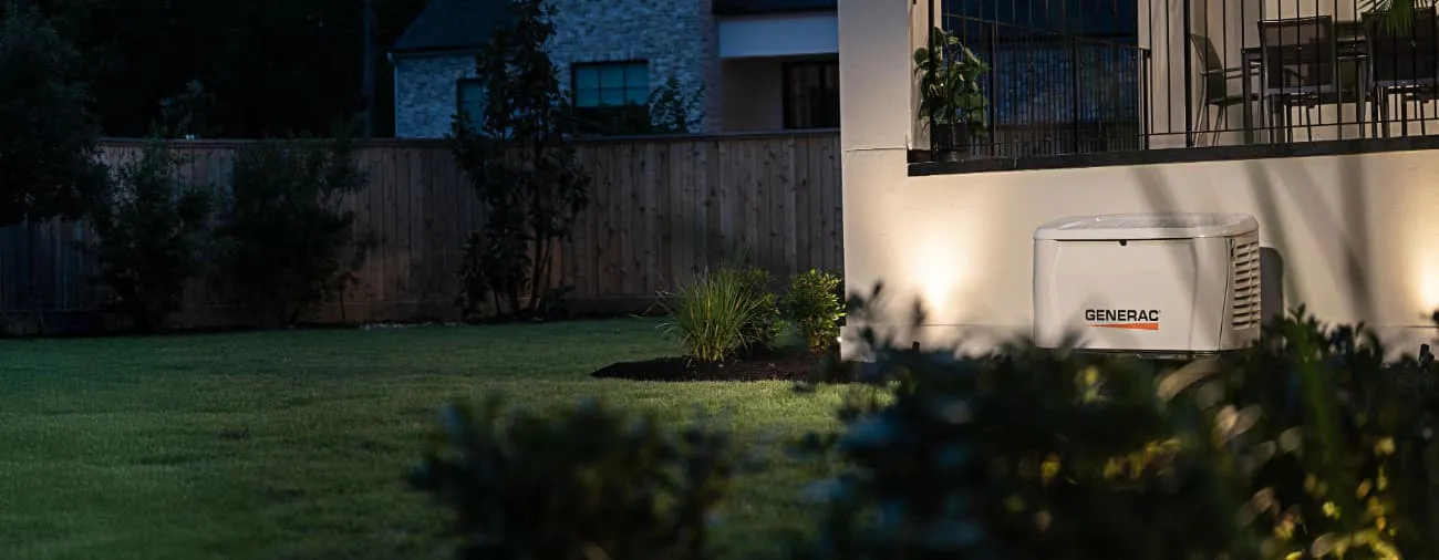Generac home standby generator providing backup power beside a home