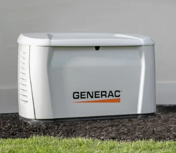 Home standby generator installed beside a residence